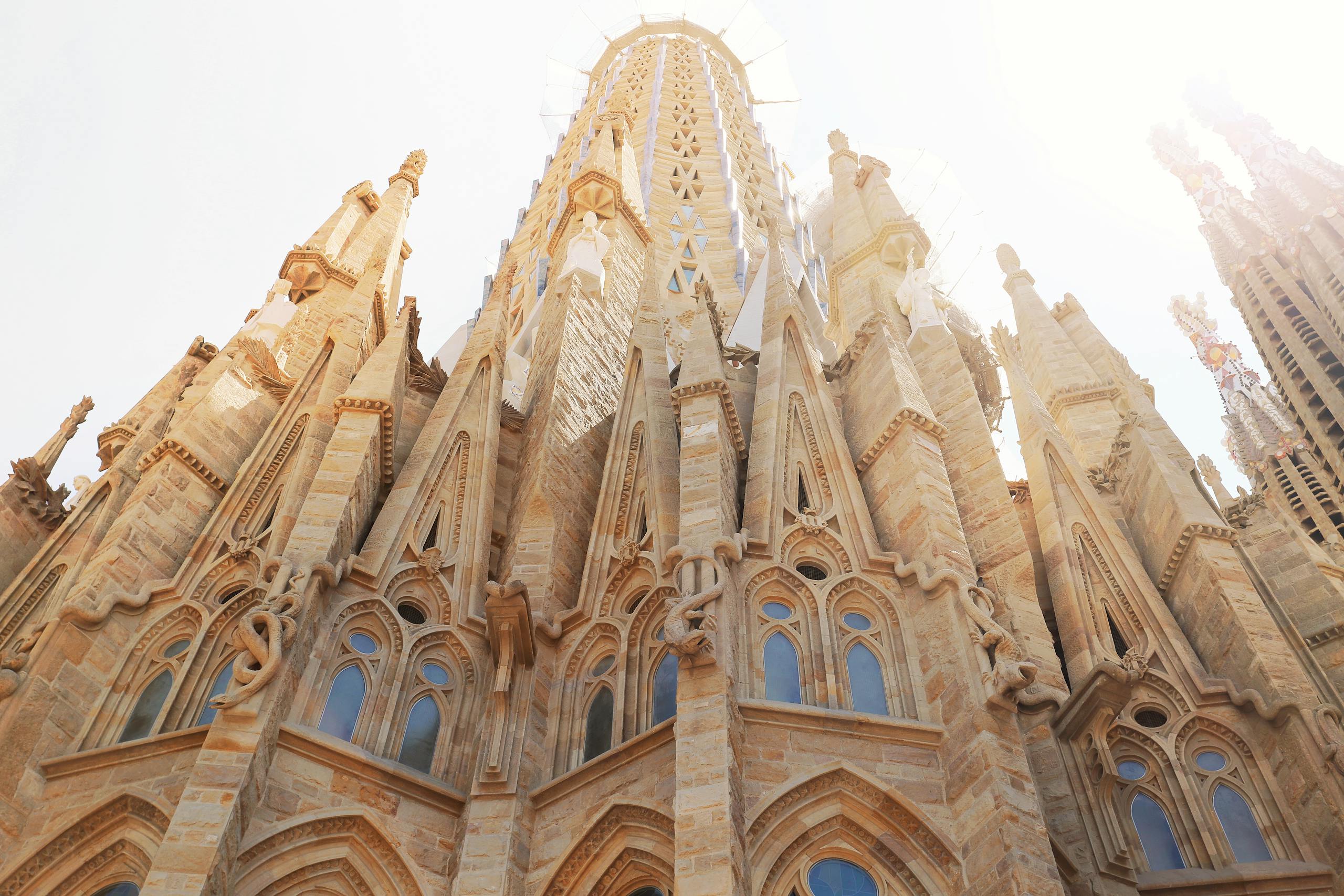 Low angle view of the iconic Sagrada Familia, revealing its intricate architecture in Barcelona, Spain.