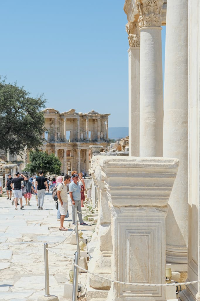 Tourists explore the historic Library of Celsus, a prominent landmark in Ephesus, Turkey.